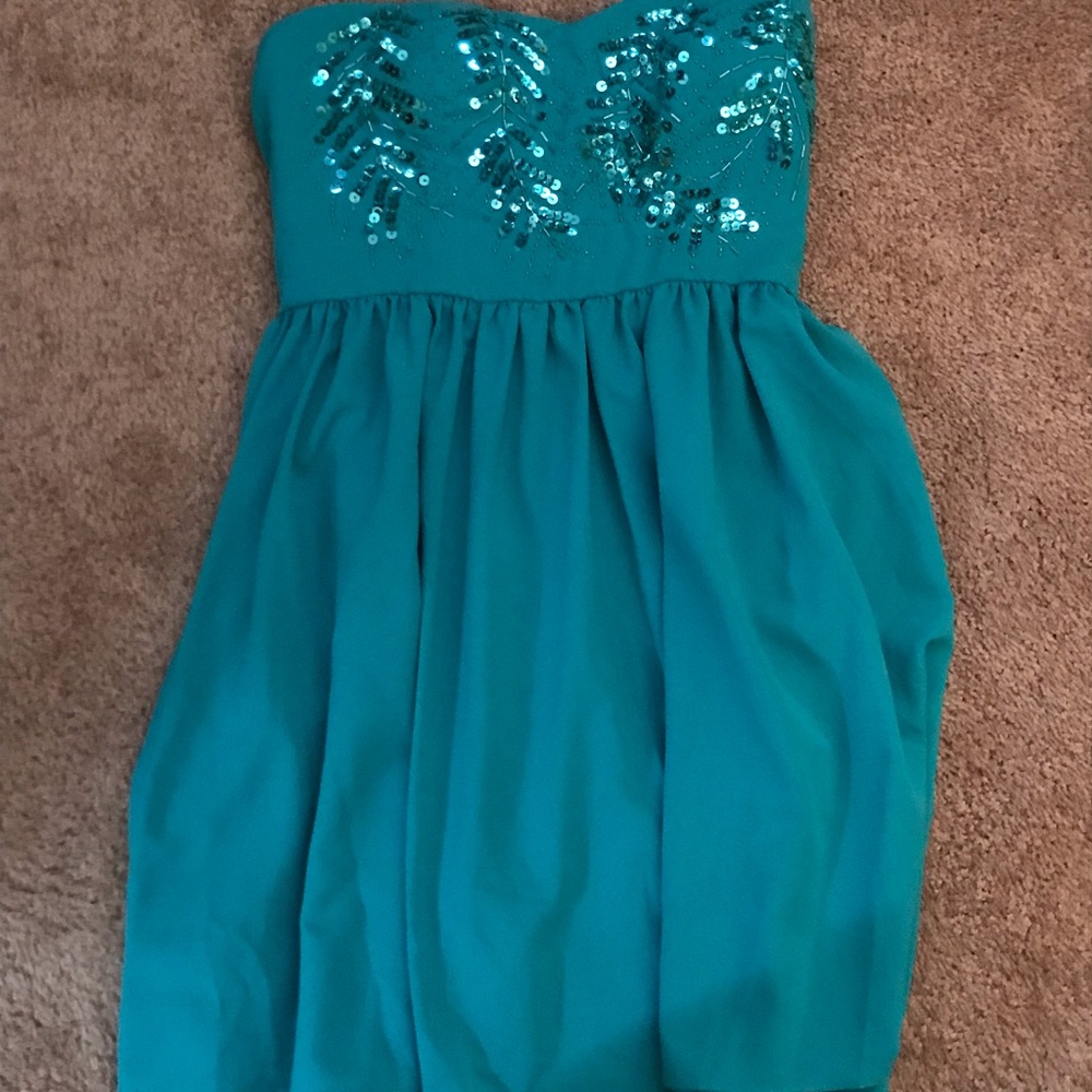 Small, teal strapless dress with detail